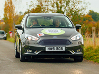 Rebekah Deponeo driving toward camera